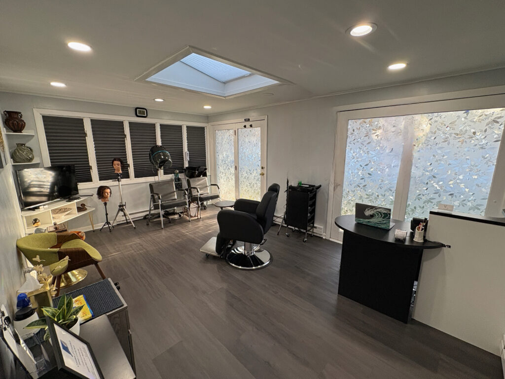 A room with a lot of windows and a desk