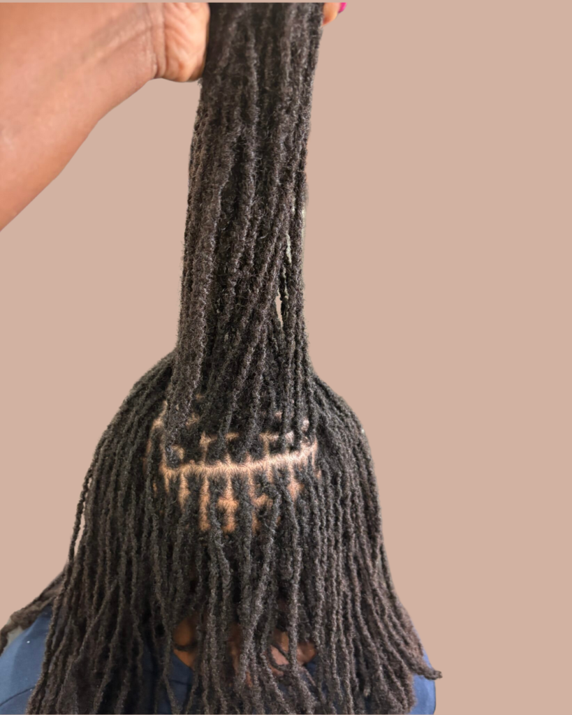 A person holding their hair in the air